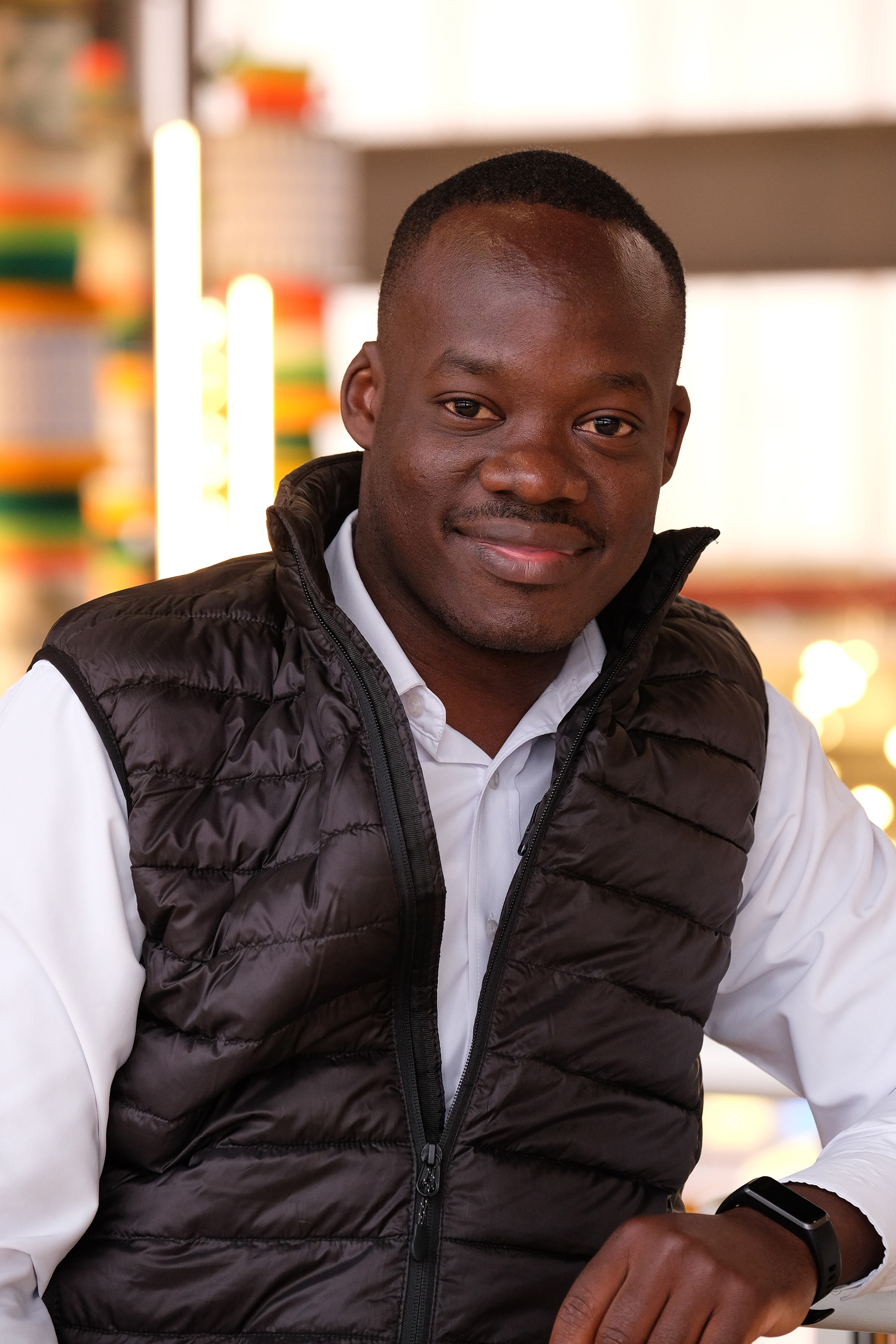 Dennis okova wearing a black half jacket